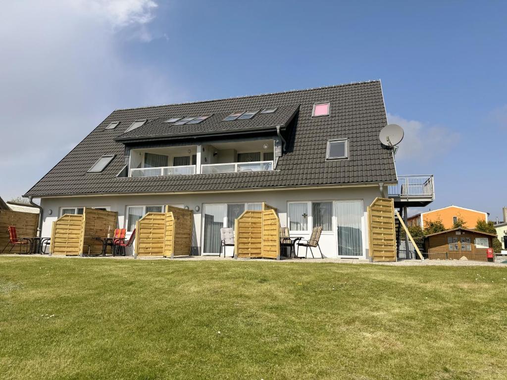 a house with solar panels on top of it at Haus Inselperle mit Blick auf den Bodden in Alt Reddevitz