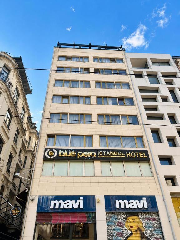 a large building with a sign on the side of it at Blue Pera İstanbul Hotel in Istanbul