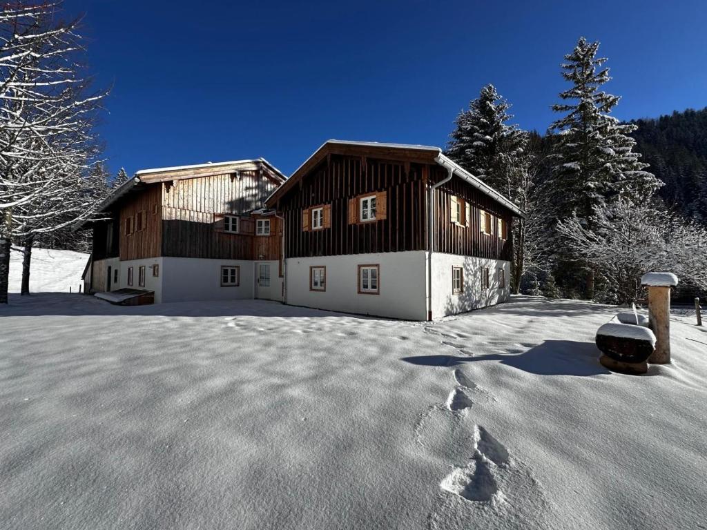 a house in the snow with a lot of snow at Mitteralm-Kreuth in Kreuth