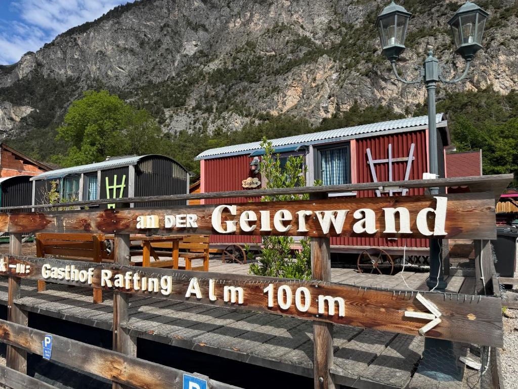 a train at a train station with a sign at an der GEIERWAND in Haiming