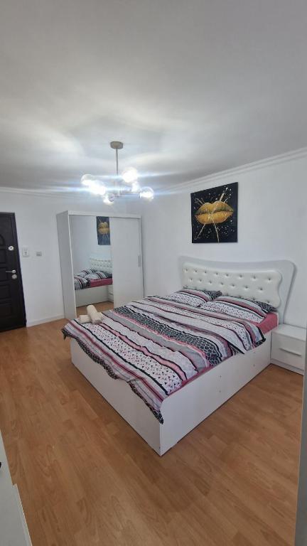 a bedroom with a bed with a quilt on it at Gabriela Studio in Drobeta-Turnu Severin
