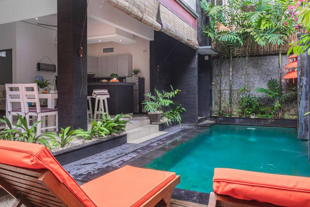 a pool in the backyard of a house at Villa Mali Legian in Legian