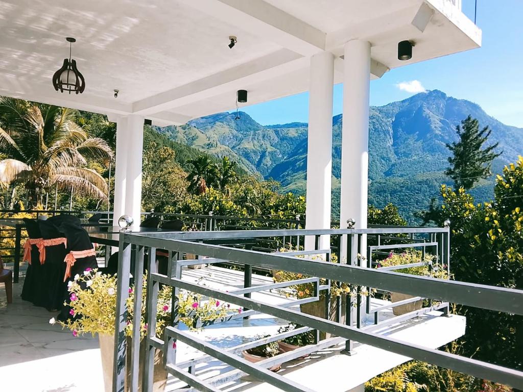 a view from a porch with mountains in the background at Devil mountain villa- kalupahana in Etimole