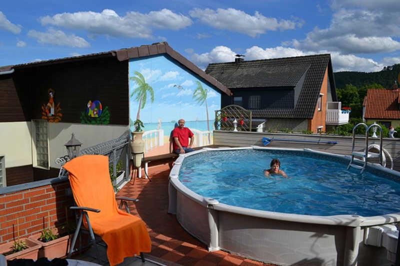 a woman is swimming in a large swimming pool at Ferienwohnung Anneli Edert in Bad Harzburg