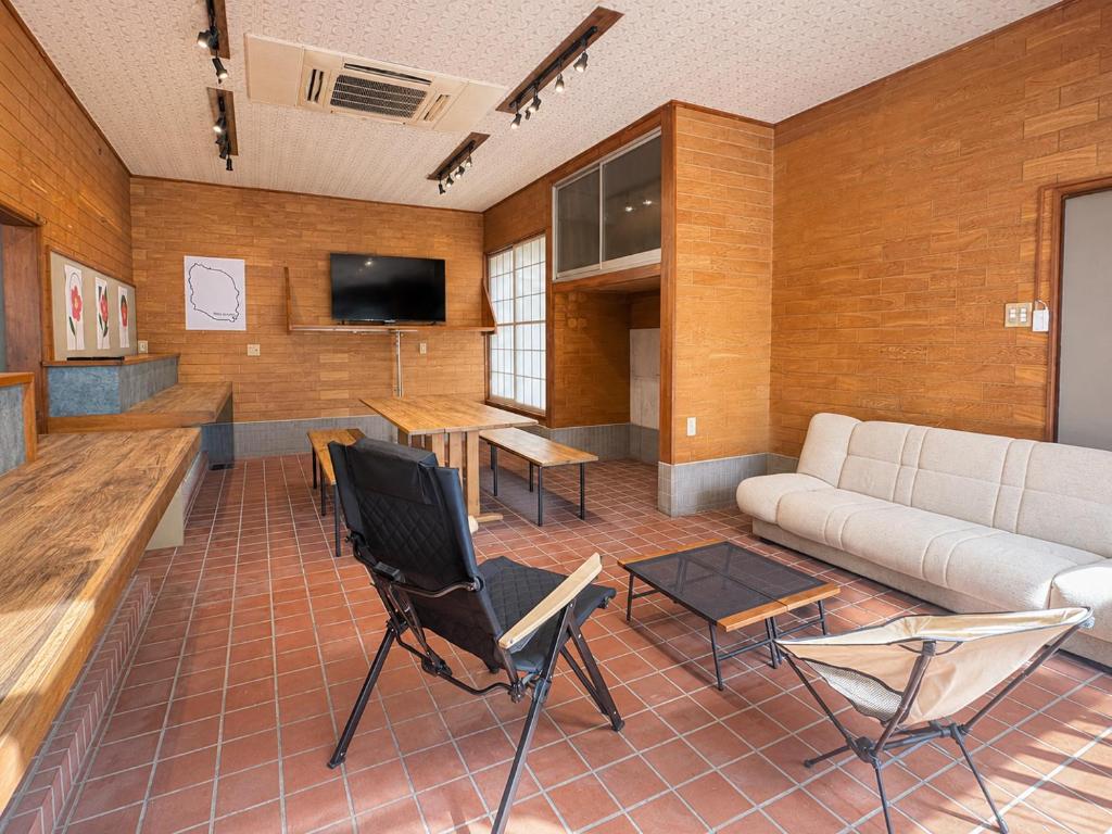 a living room with a couch and chairs and a table at Hav Living in Oshima