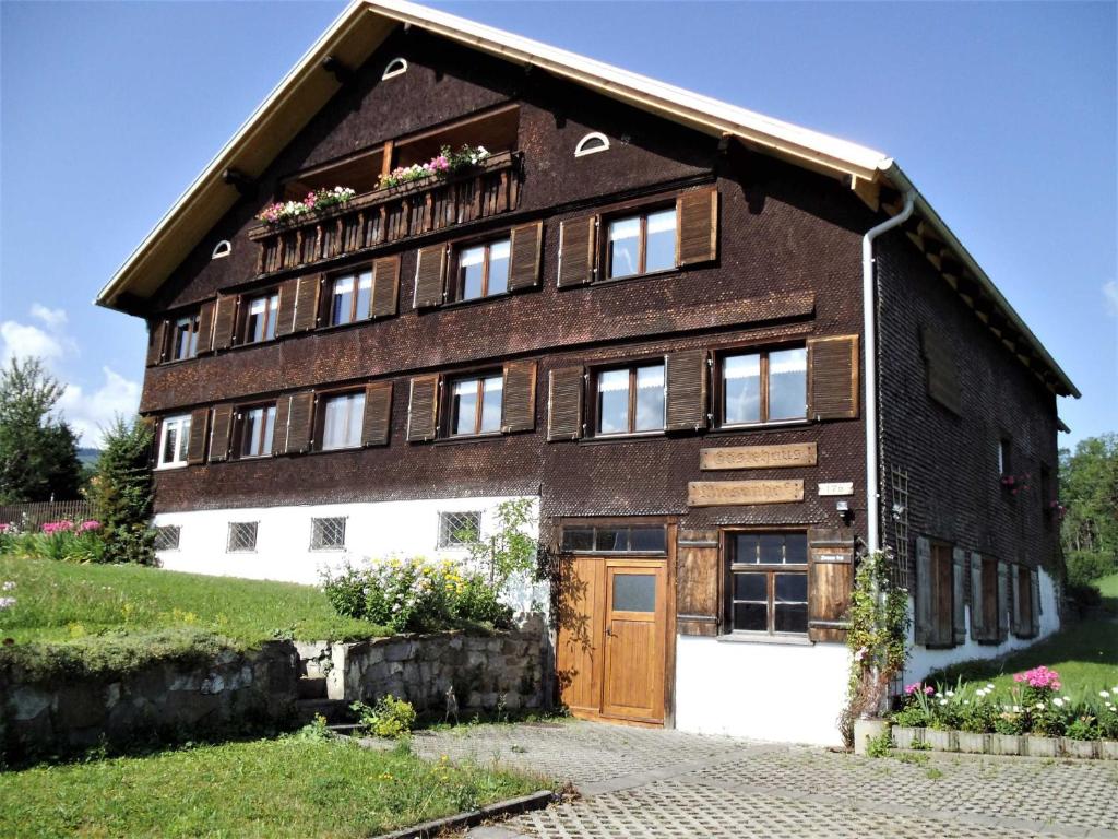 a large brick building with windows and a door at Gästehaus Wiesenhof in Schwarzenberg