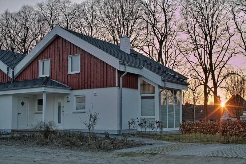 a white and red house with a red roof at Ferienhaus Luan in Nordhorn