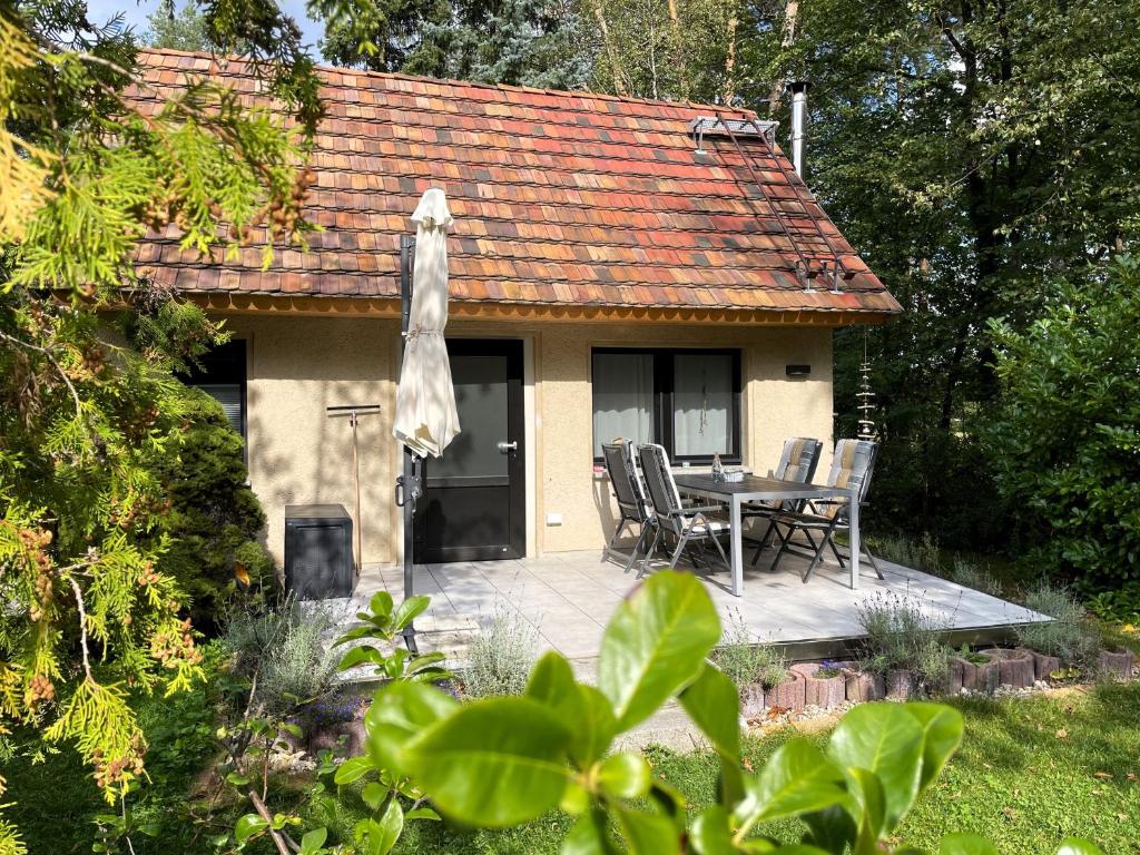 a house with a patio with a table and chairs at Hoffmannshof in Torno