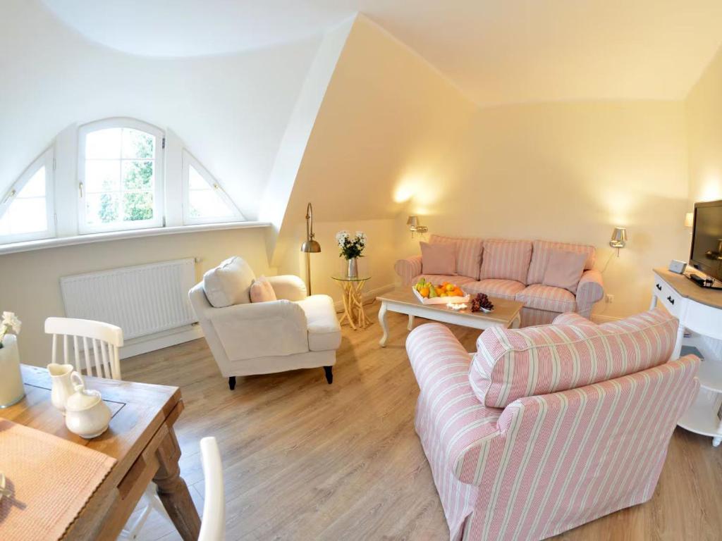 a living room with two couches and a table at MR Landhaus Uhlenhof 5 in Groß Zicker