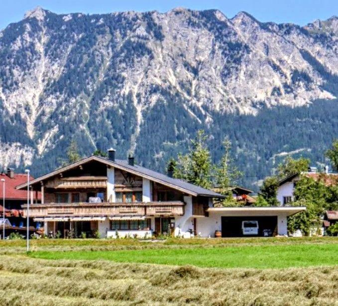 a large house in front of a mountain at Hoamatl in Tannheim