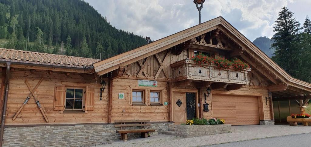 a wooden building with a bench in front of it at Haus Walina in Tannheim
