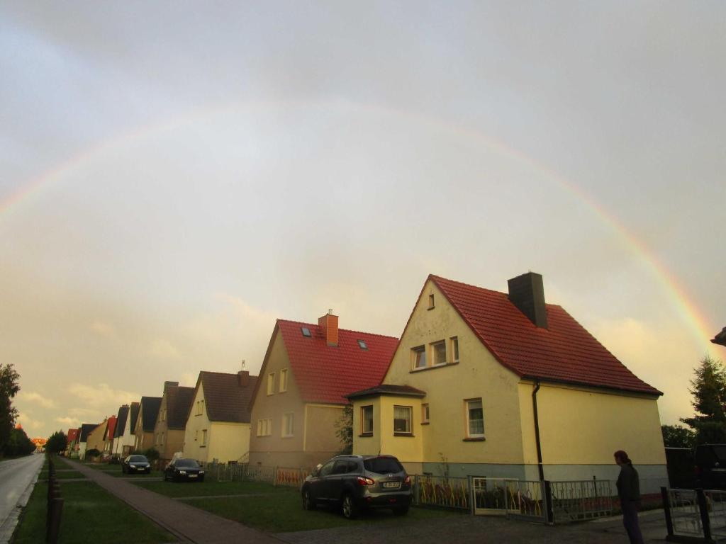 a rainbow in the sky over a row of houses at Ferienhaus 2 Bernd in Barth