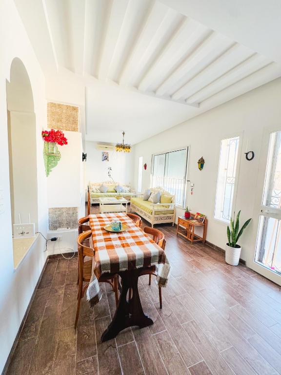 a living room with a table and a couch at La Maison de haut in Tunis