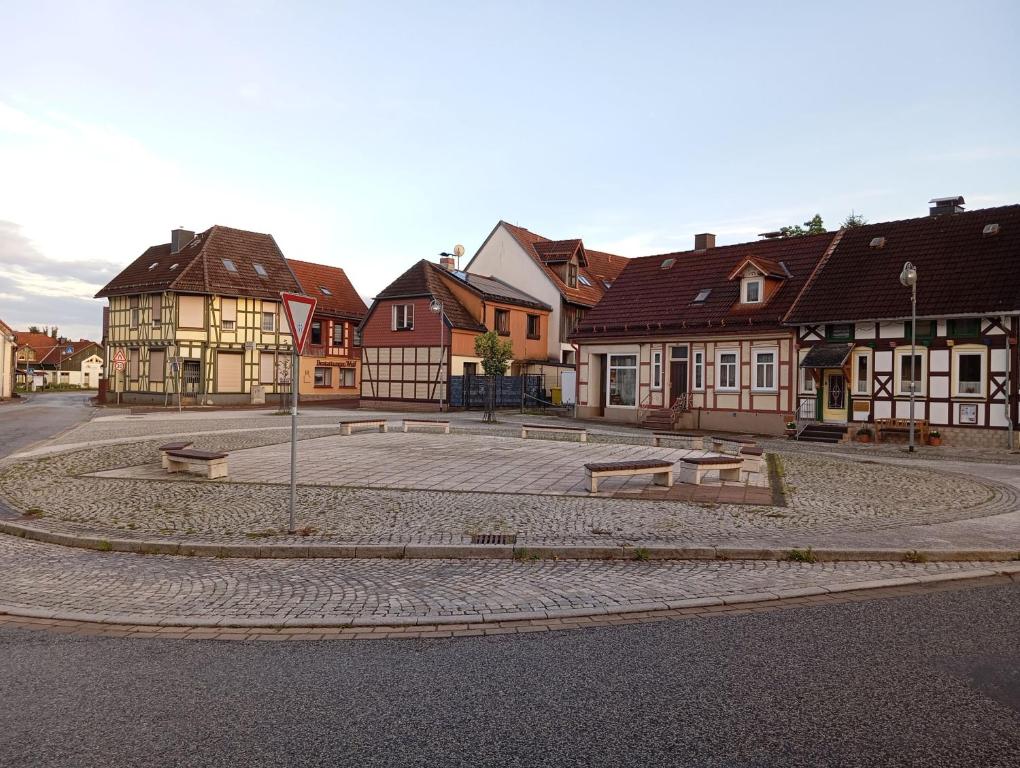 a street with houses and benches in a town at Ferienhaus Max Schmeling in Benneckenstein
