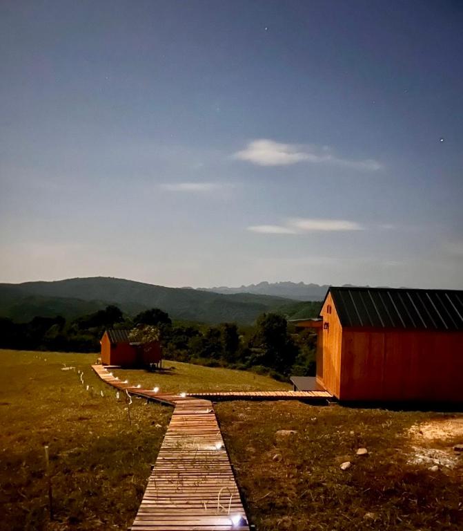 a pathway leading to a red barn in a field at Hillbilly Farm in Ban Kok Kabok