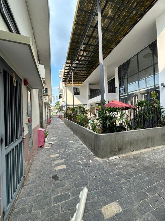 an empty walkway in a building with tables and umbrellas at Tam duc villa in Tây Ninh