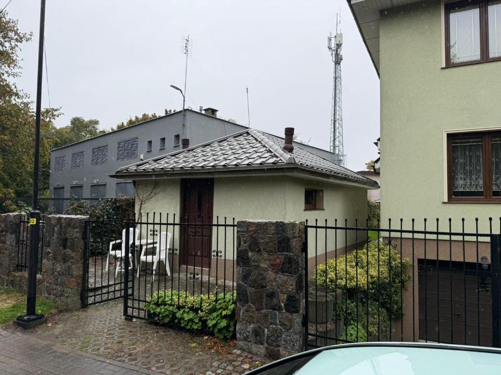 a house with a fence in front of it at Mini Apart - Gdańsk Jelitkowo in Gdańsk