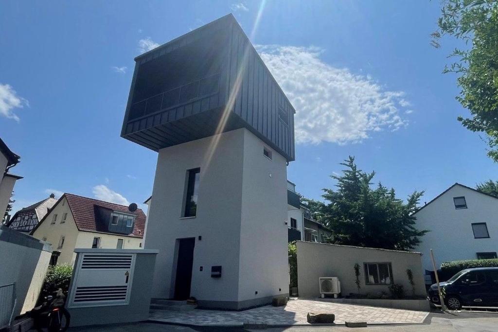 a house with a black roof on top of it at Turmquartier Weinsberg in Weinsberg