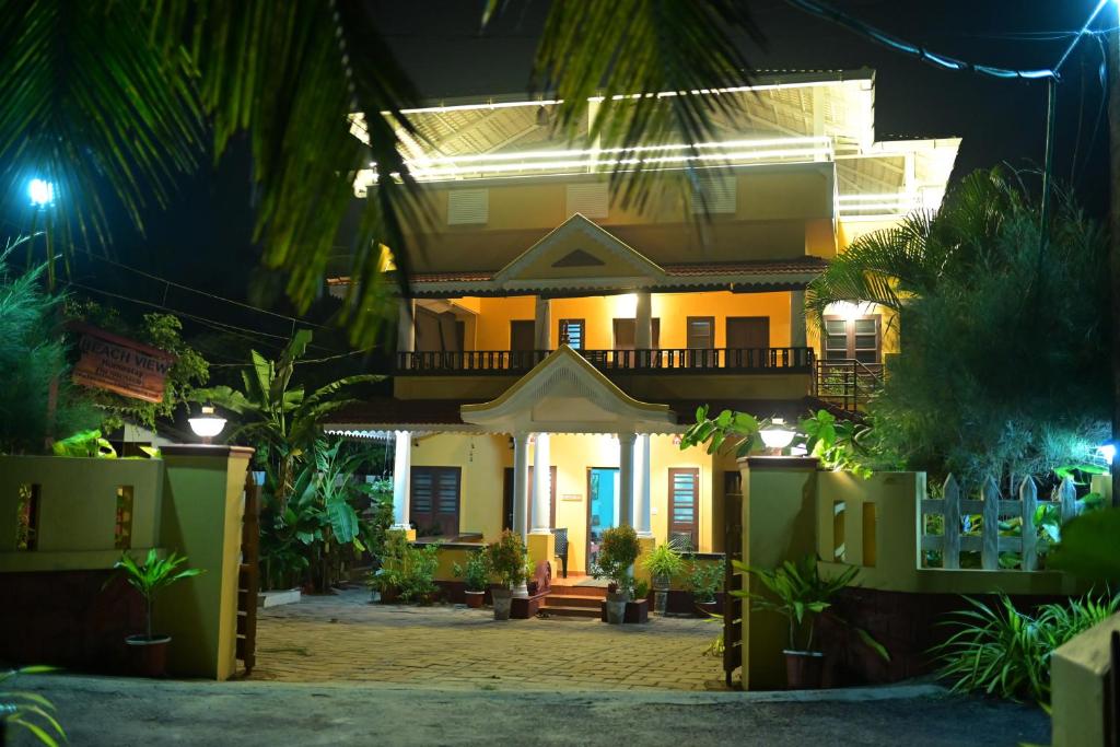a house at night with a lot of plants at Kannur Beach view Homestay in Kannur