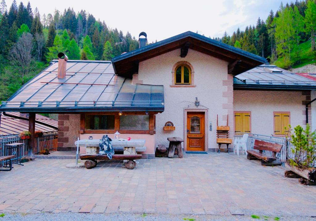 a house with a large patio in front of it at Dolomiti Cadore Home in San Pietro di Cadore