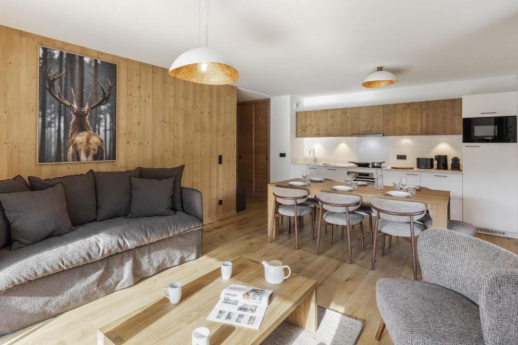 a living room with a couch and a table at Alpine Blanc - Neuf, calme & Wellness in Saint-Gervais-les-Bains