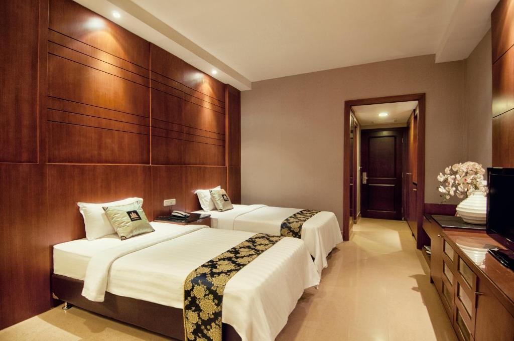 Postel nebo postele na pokoji v ubytování Grand Sakura Hotel
