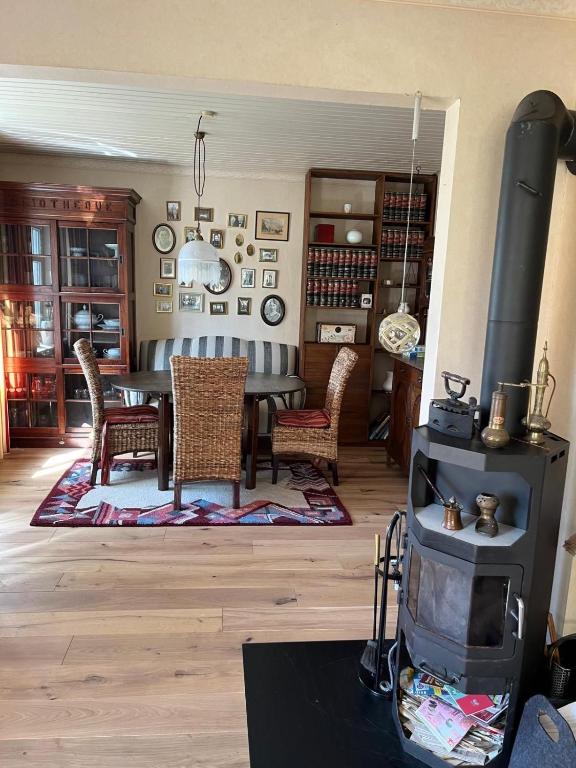 a dining room with a table and chairs and a fireplace at Ferienhaus Frerichs 15209 in Leer