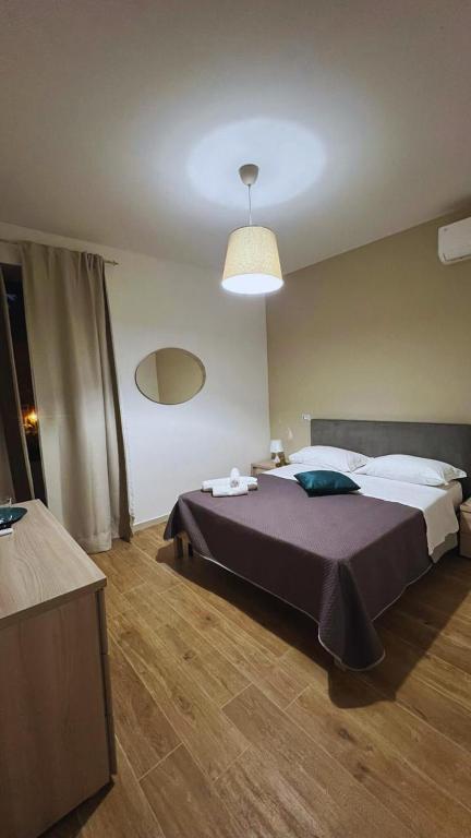 a bedroom with a large bed and a light at Masseria della Fontana Vecchia in San Cipriano Picentino