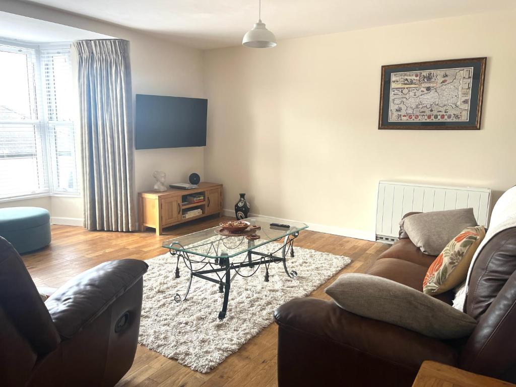 a living room with a couch and a table at Tredenwith House in St. Just