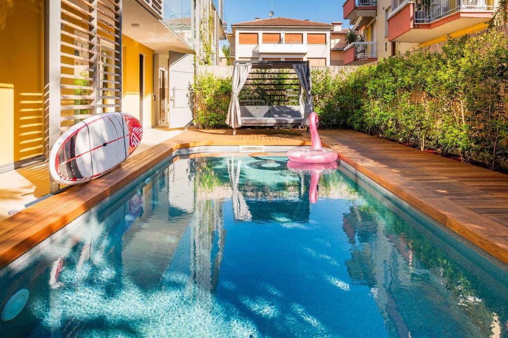 a swimming pool with a playground in a house at Mirabello Private Pool Apartment in Bardolino
