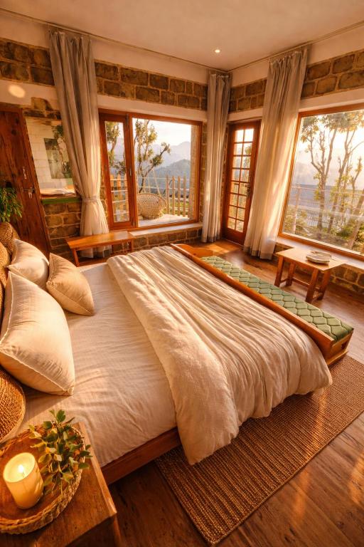 a large bed in a room with windows at Vista Hostel Jeolikote, Nainital in Patwa Dunga