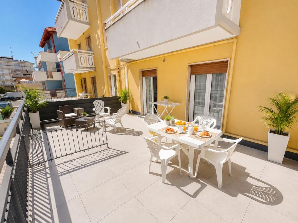 a patio with a table and chairs on a balcony at RESIDENCE PACE - Agenzia Cocal in Caorle