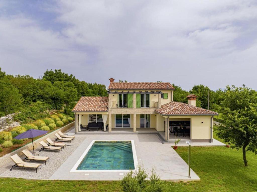 a house with a swimming pool in the yard at Villa Fortuna - Private Pool and Garden Retreat in Labin