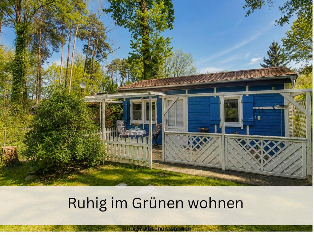 a blue tiny house with a white fence at Schwedenglück - Wald-Auszeit für 2 in Dahlen