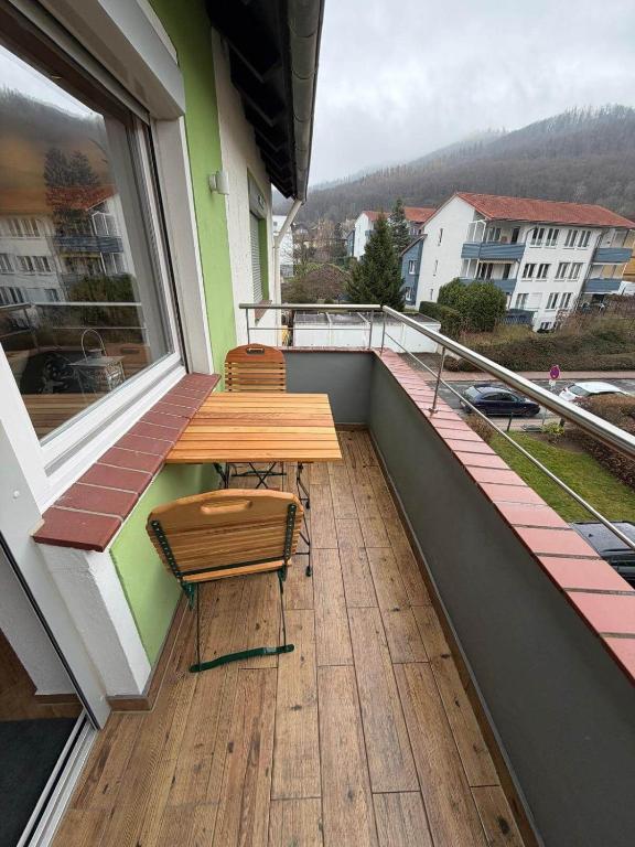 a balcony with a wooden table and chairs on it at Ferienwohnung Harzoase in Bad Harzburg