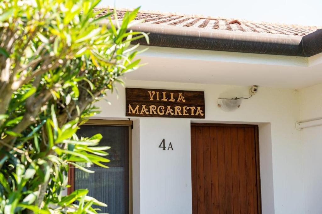 a sign on a building that reads villa margarita margarita at Margareta in Caleri