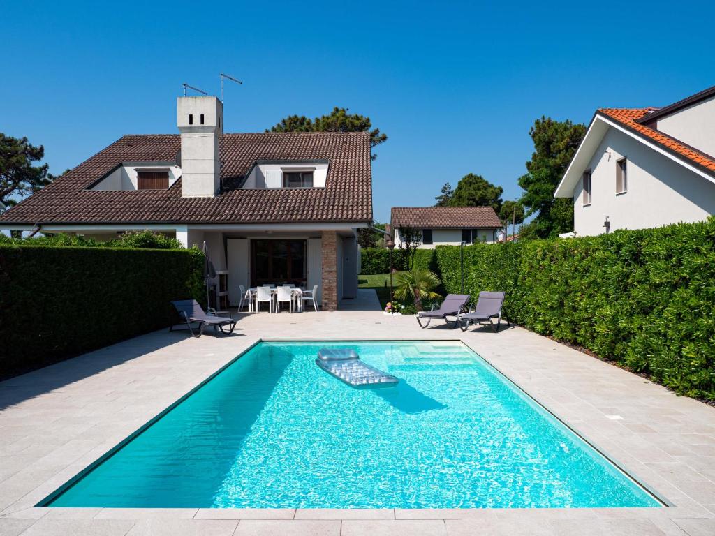 a swimming pool in front of a house at Fortuna in Palazzo Vianello