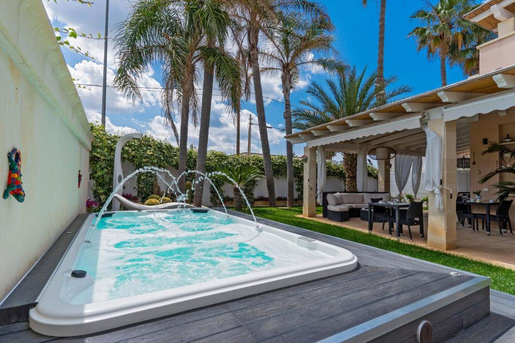 a hot tub in the backyard of a house at B&B Annita in Porto Cesareo