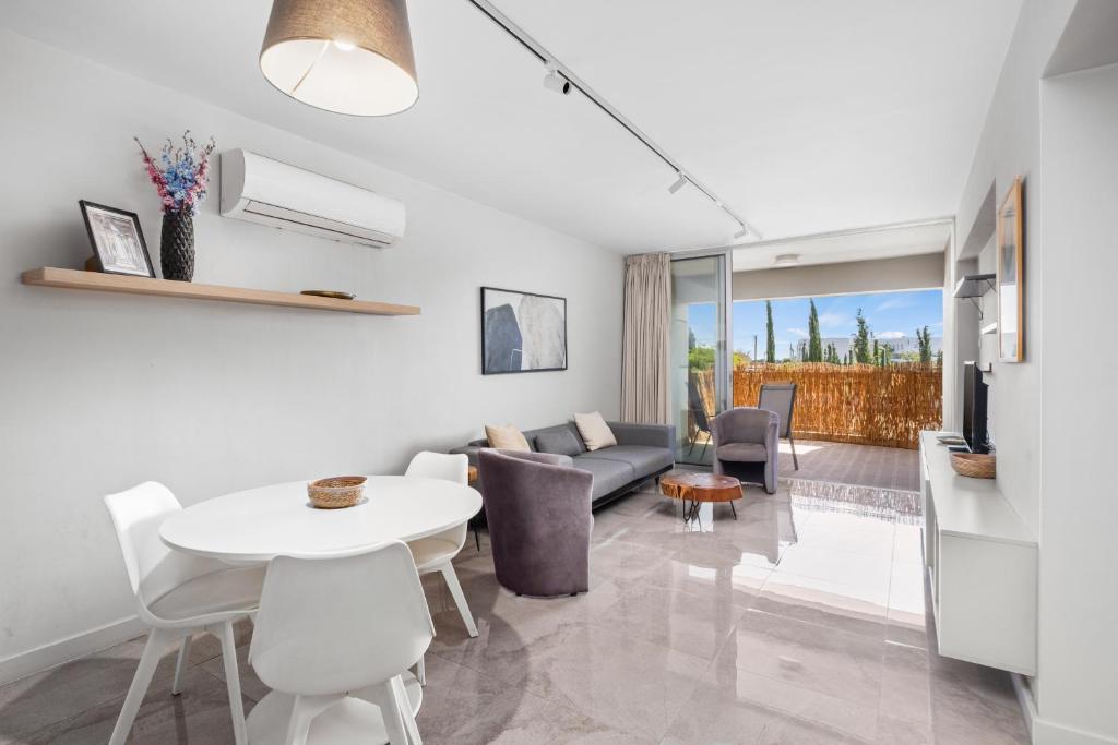 a living room with a white table and a couch at Latitudes 1 Bedroom Apartment in Meneou