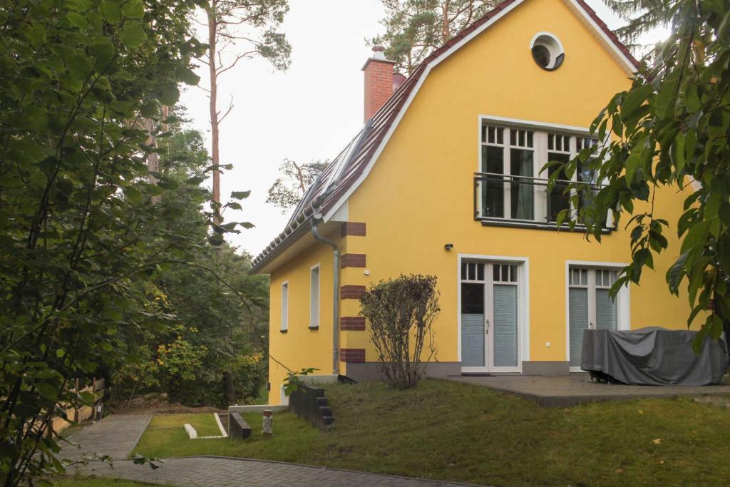 a yellow house with a table in front of it at Villa Liselotte in Fürstenberg