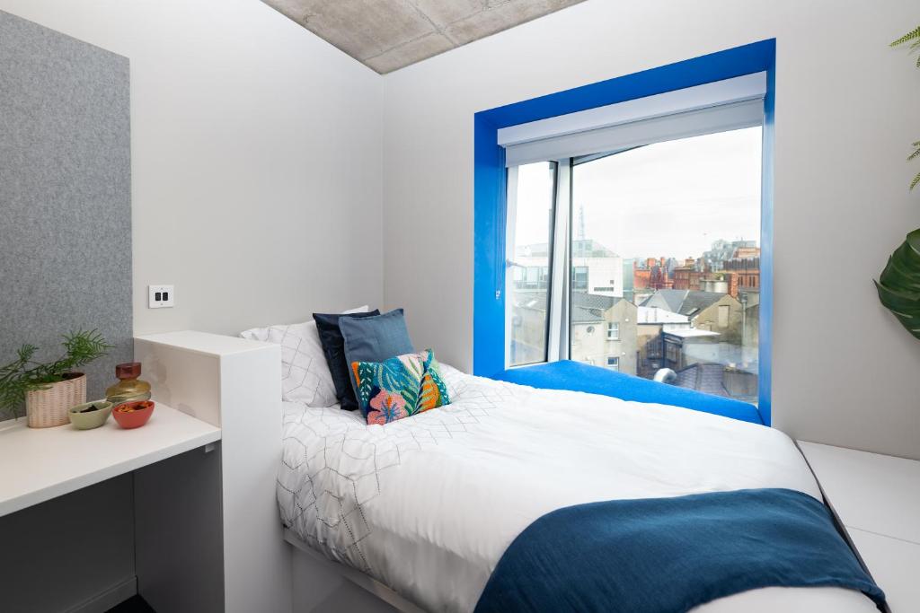 a bedroom with a bed and a large window at Stephen's Quarter - Aparto in Dublin