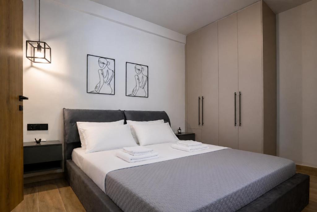 a bedroom with a large bed with white sheets at Latitude 37 Luxe in Kalamata