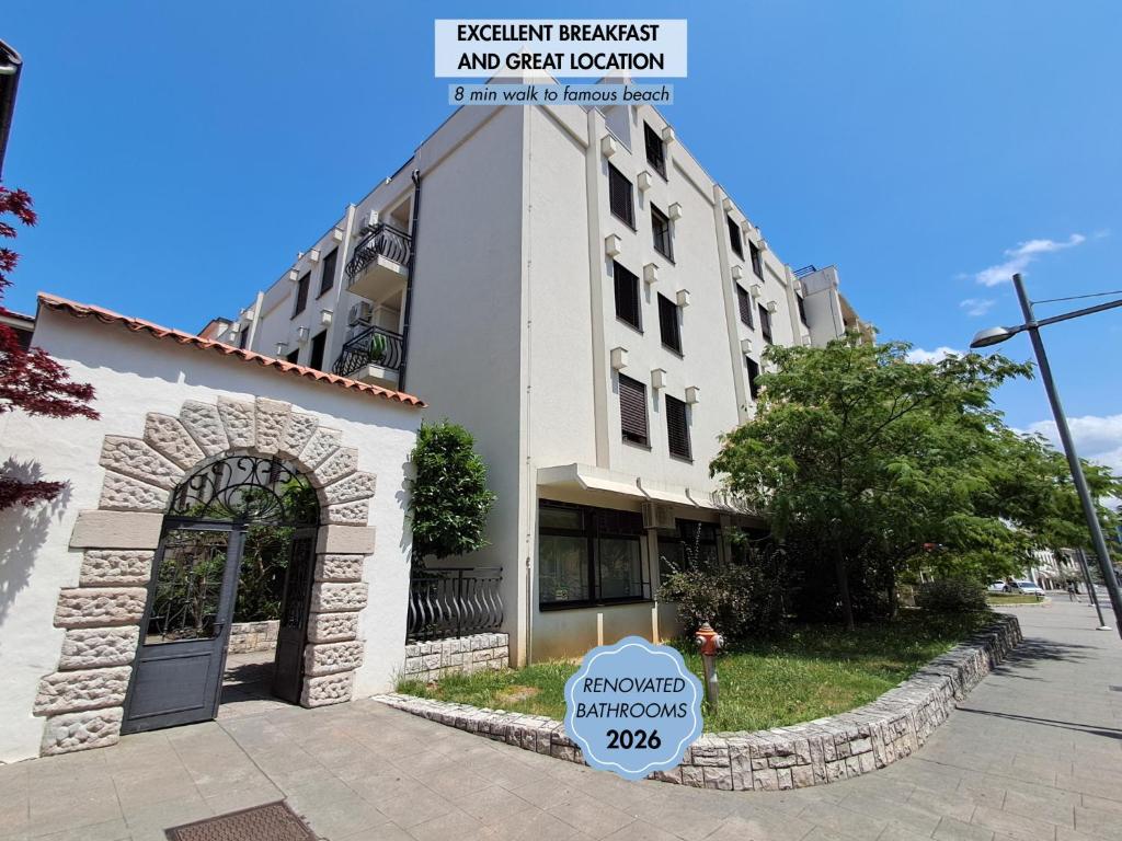 a white building with a sign in front of it at Mediterranean Rooms Koper in Koper