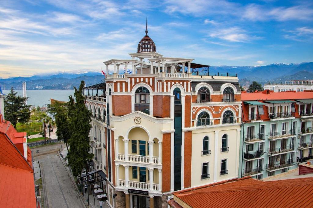 a large building with a tower on top of it at Batumi World Palace in Batumi
