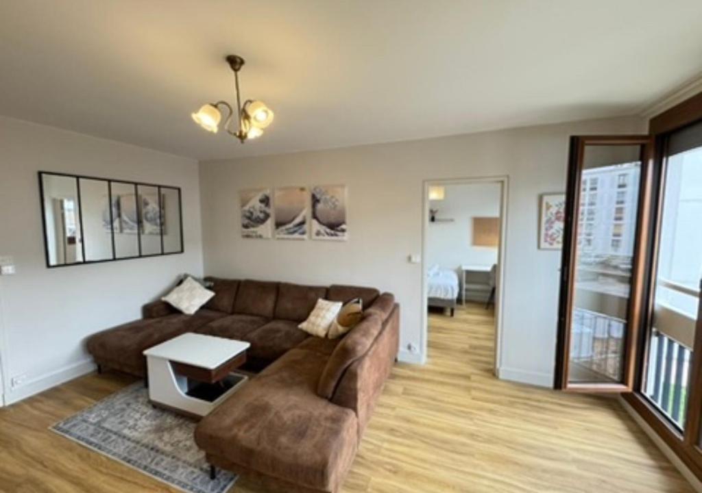 a living room with a couch and a table at T5 cosy lumineux in Amiens