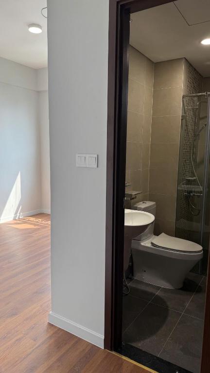 a bathroom with a toilet and a sink at Cara Riverside Cần Thơ- 2 mins GO Cần Thơ in Can Tho