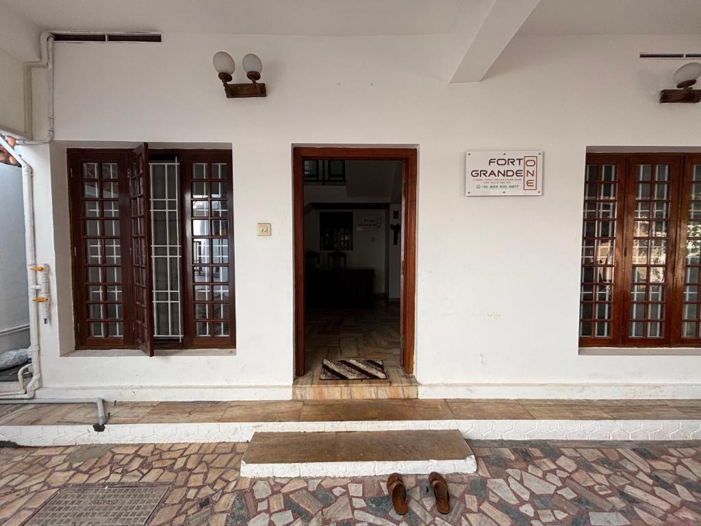 an open door of a building with a sign on it at Fort Grande ONE in Cochin