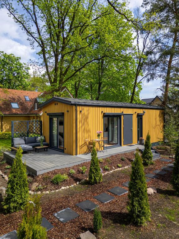 a yellow tiny house in a garden at Hygge Tiny House 2 - Berlin Brandenburg in Berlin