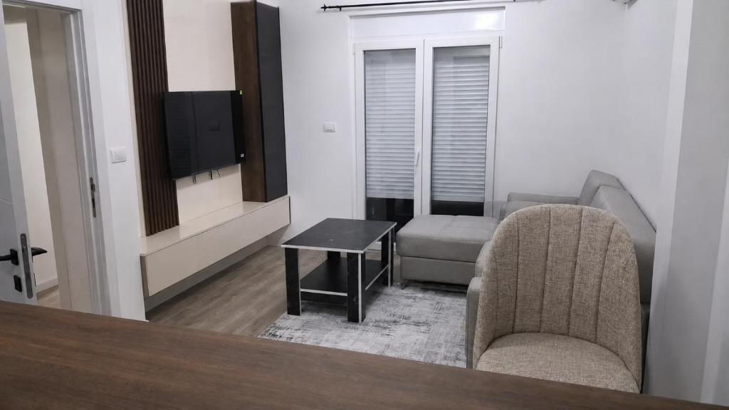 a living room with two chairs and a table and a television at Cozy aparment Susanj,Bar in Bar