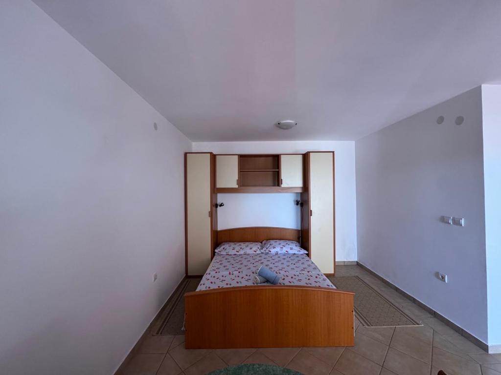 a small bedroom with a bed in the corner at SS Pearl Apartment in Utjeha